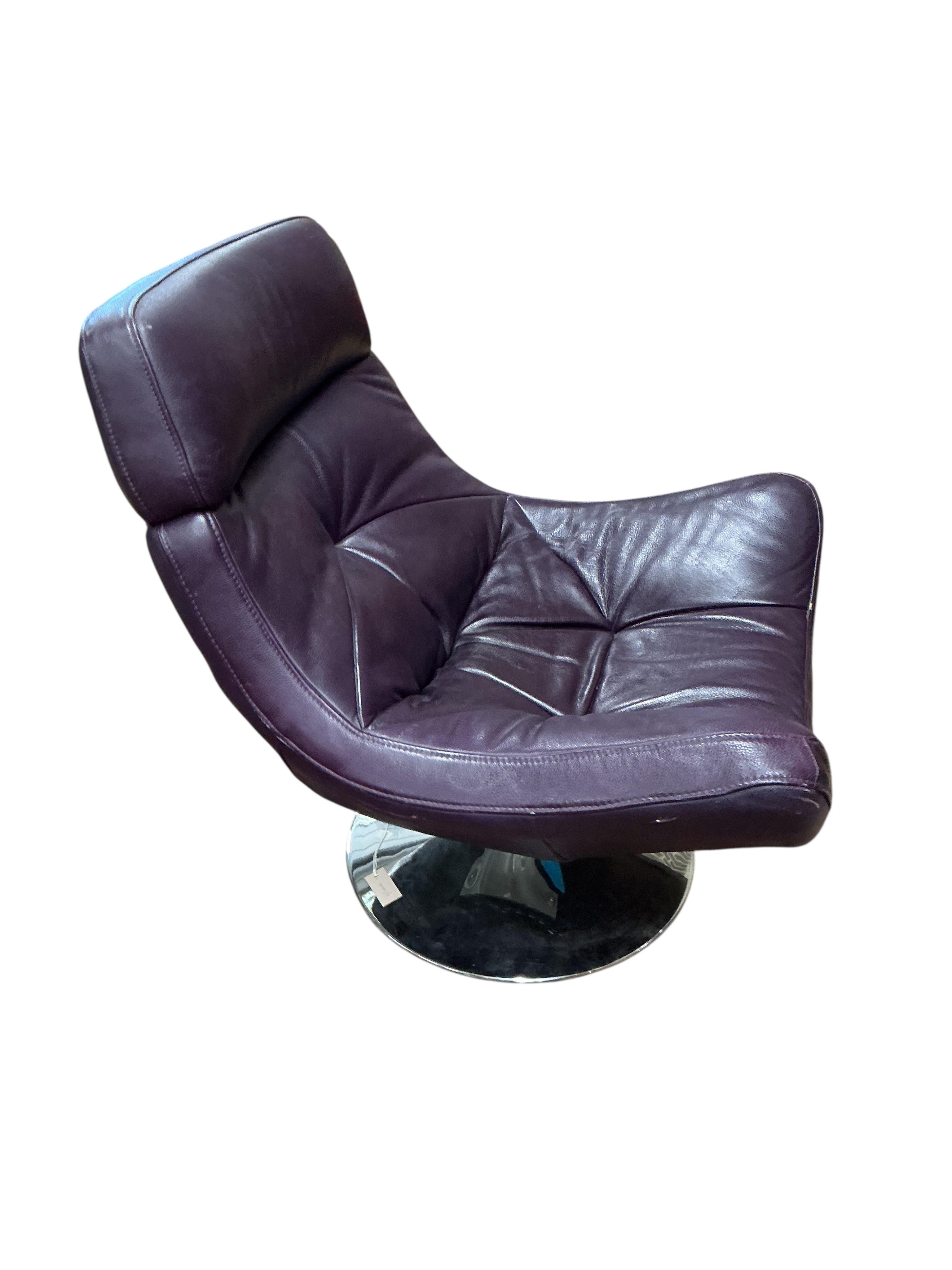 A Contemporary revolving recliner chair, upholstered in purple leather, width 82cm, depth 86cm, height 96cm